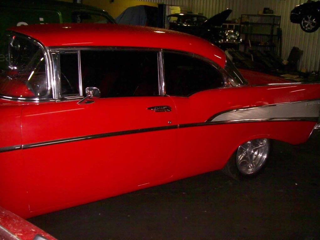 a red car with a white stripe on the side