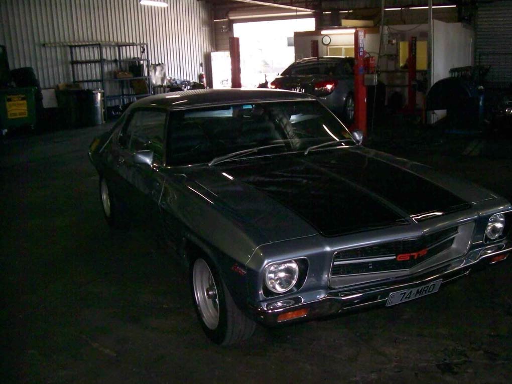 a green car with a black stripe