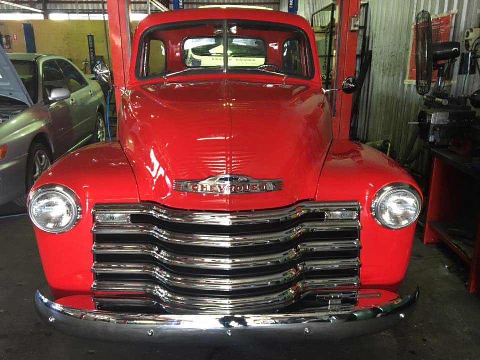the grill of a cherry red car