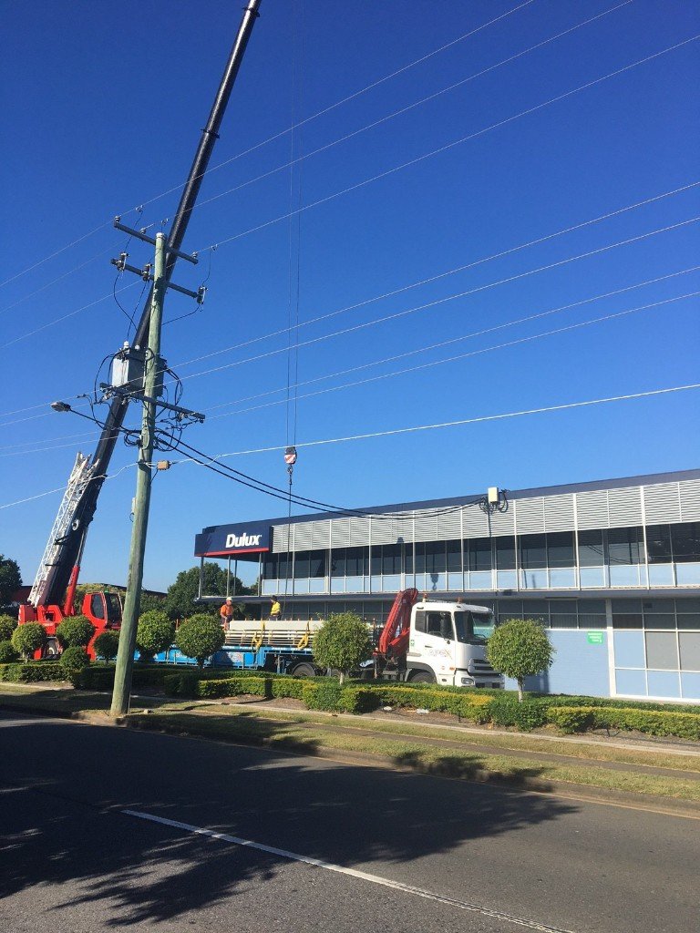 new roof sheeting being craned onto roof