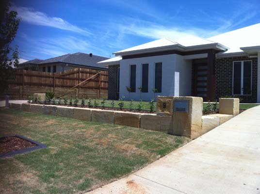 home with stone retaining wall