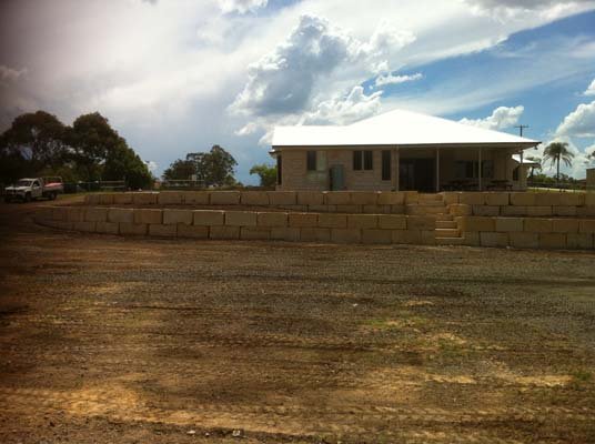 large cleared area with retaining wall