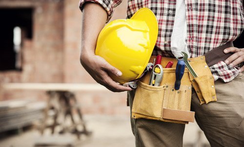 a engineer stand with construction tools on construction site