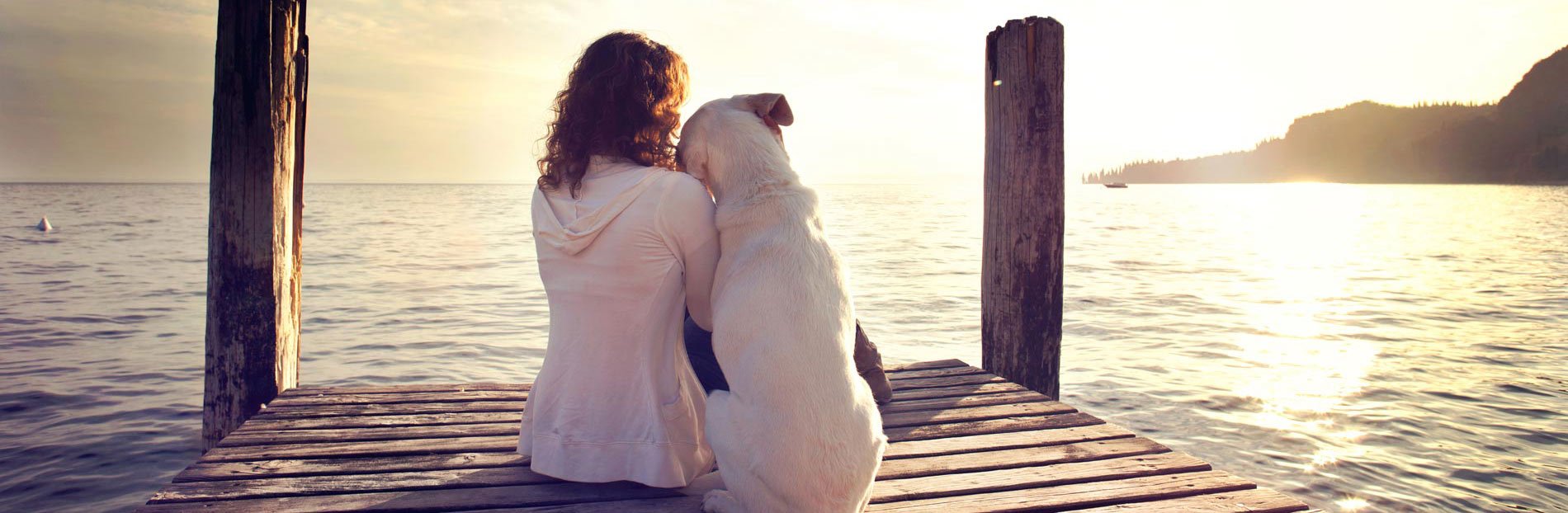 woman with dog on pier