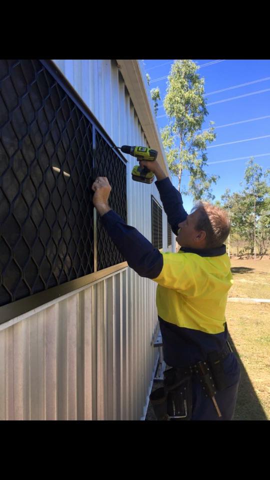 Man installing security screen