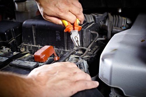 Electrical repair being done by car mechanic 