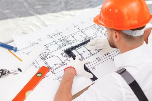 A man looking at building plans
