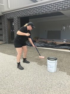 woman rolling sealant