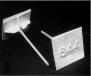 A black and white photo of two pieces of metal on a black background.