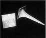 A black and white photo of a horn and a piece of paper.