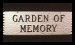 A white sign that says garden of memory on it