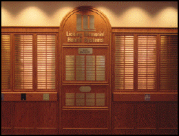 A wooden wall with a sign that says george memorial health systems