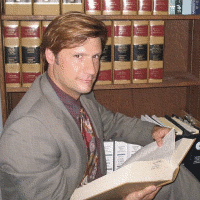 Eric Krasle Holding a Book — Watkinsville, GA — Law Offices of Eric K. Krasle