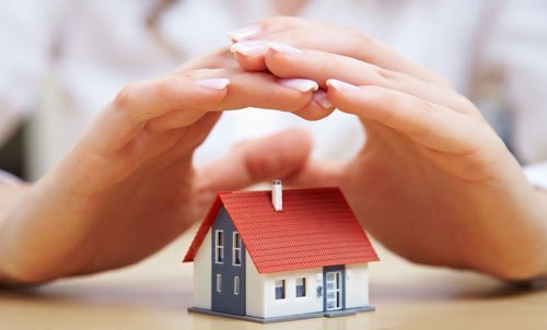 Individual protecting the house with his hands