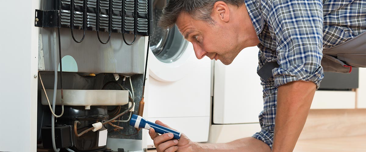 Man fixing a fridge - Rod Simpson's Appliance Service