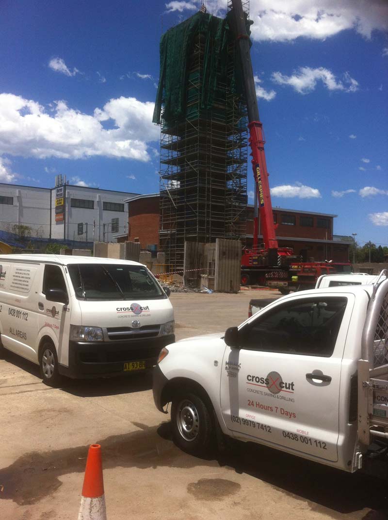 van and truck parked next to construction area