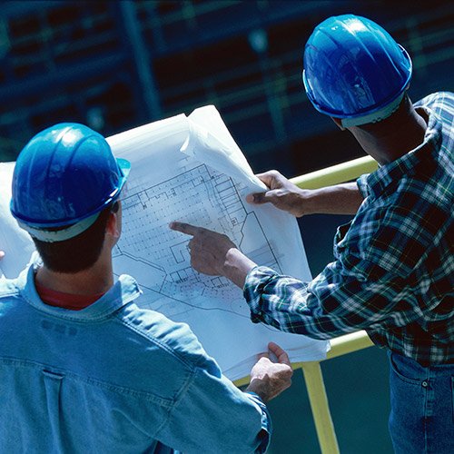 two men working with blueprint