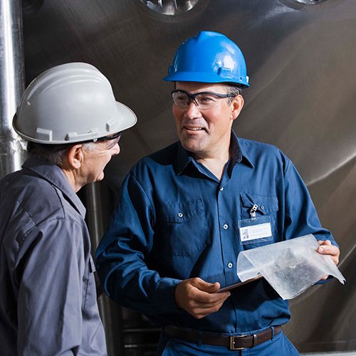 two men in hard hats talking
