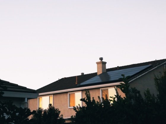 home at dusk with a solar panel
