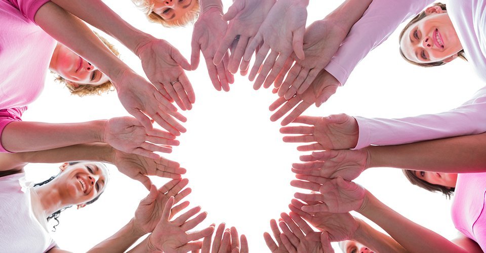 Young women forming a circle of hand 