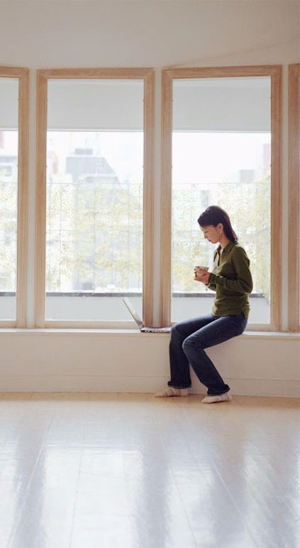 Women sitting next to the double glazed window 