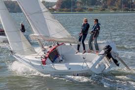 A man and a woman sailing a F22 boat