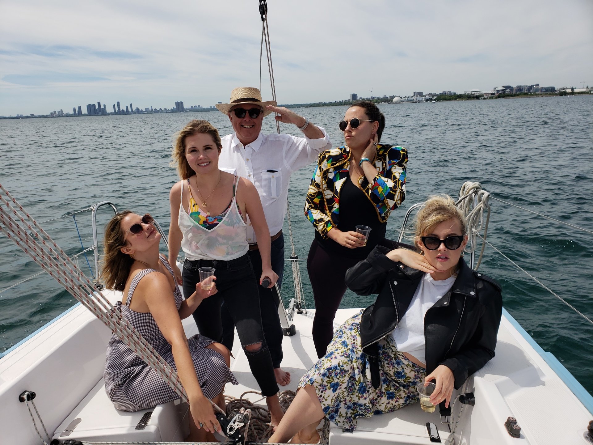 Four women and a man on the cockpit of a yacht