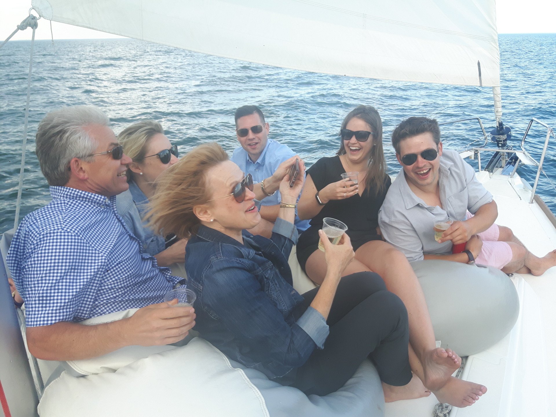 Group of smiling people drinking on a yacht
