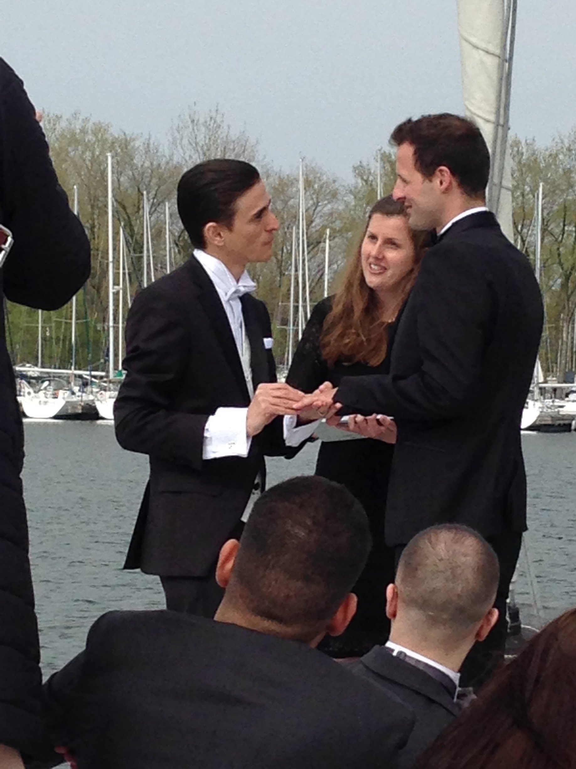 Two men getting married on a boat