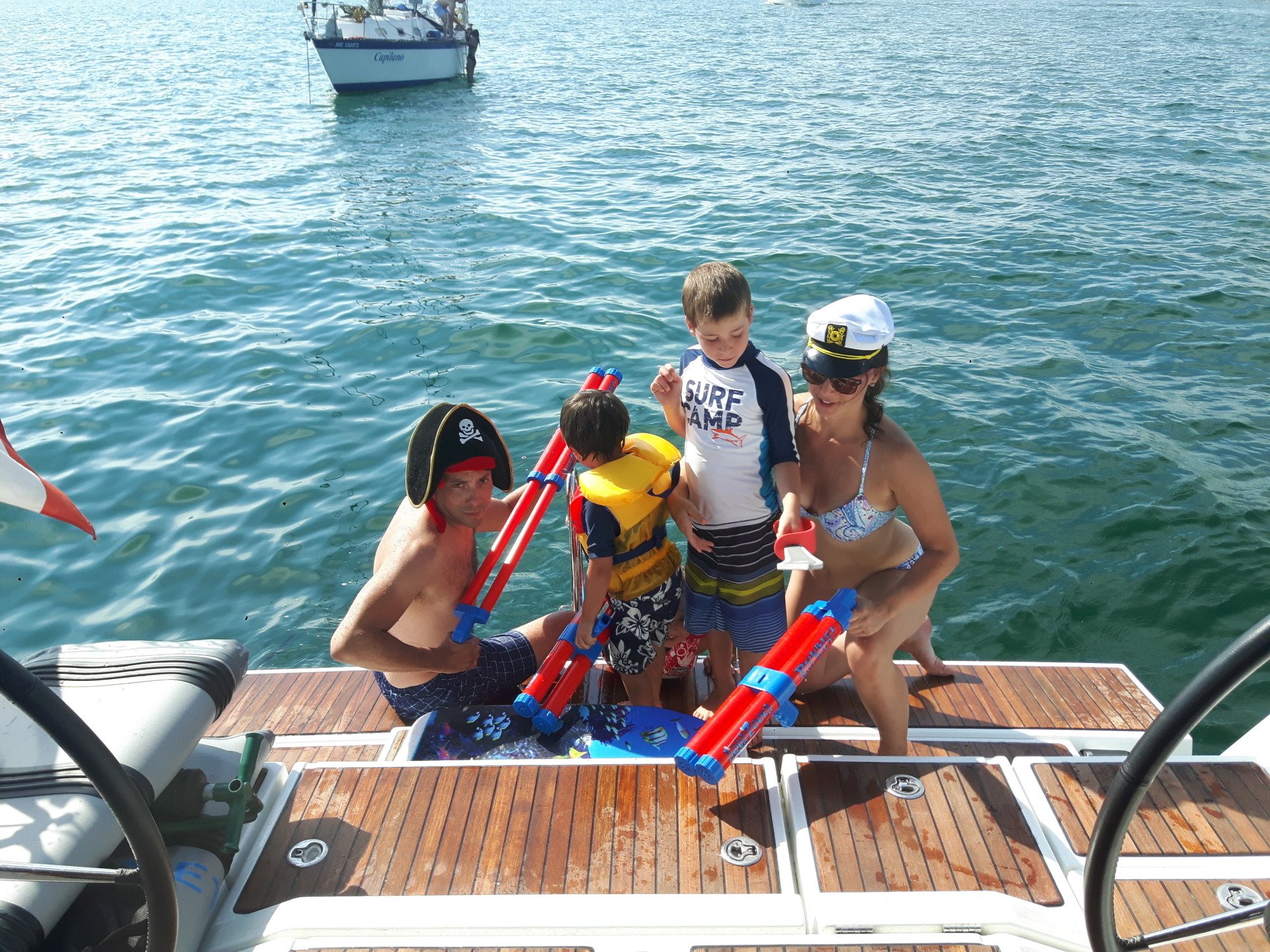 Man woman and two kids on a dock