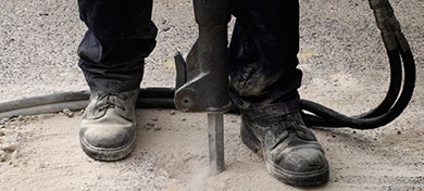 able demolitions and recyclers professional using jack hammer for the concrete floor