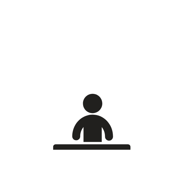 A silhouette of a person sitting at a table.