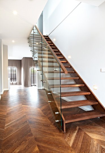 wooden staircase with glass railing