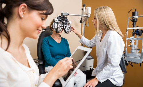 Optometrist testing the eye of patient