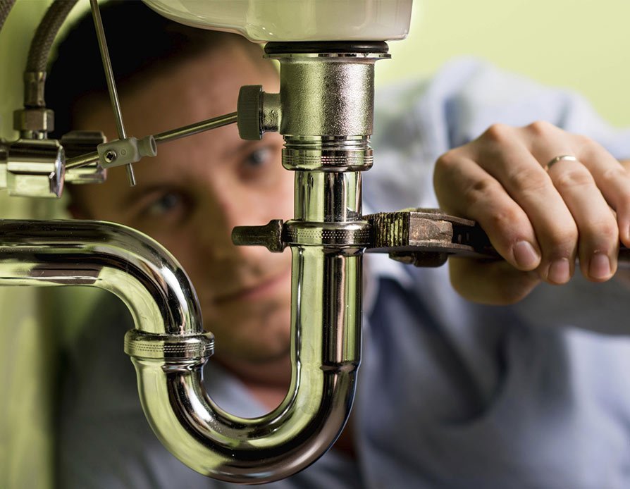 palmers plumbing and hardware pty ltd plumber fixing a sink line