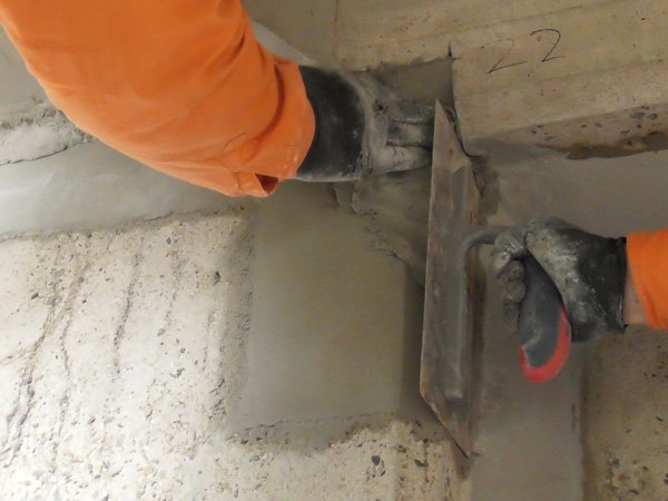 person smoothing cement