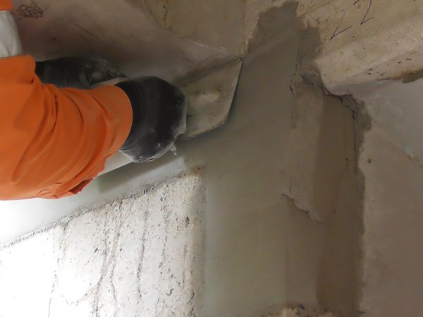 man spreading cement