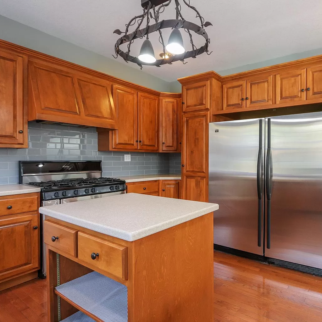 A kitchen with stainless steel appliances and wooden cabinets