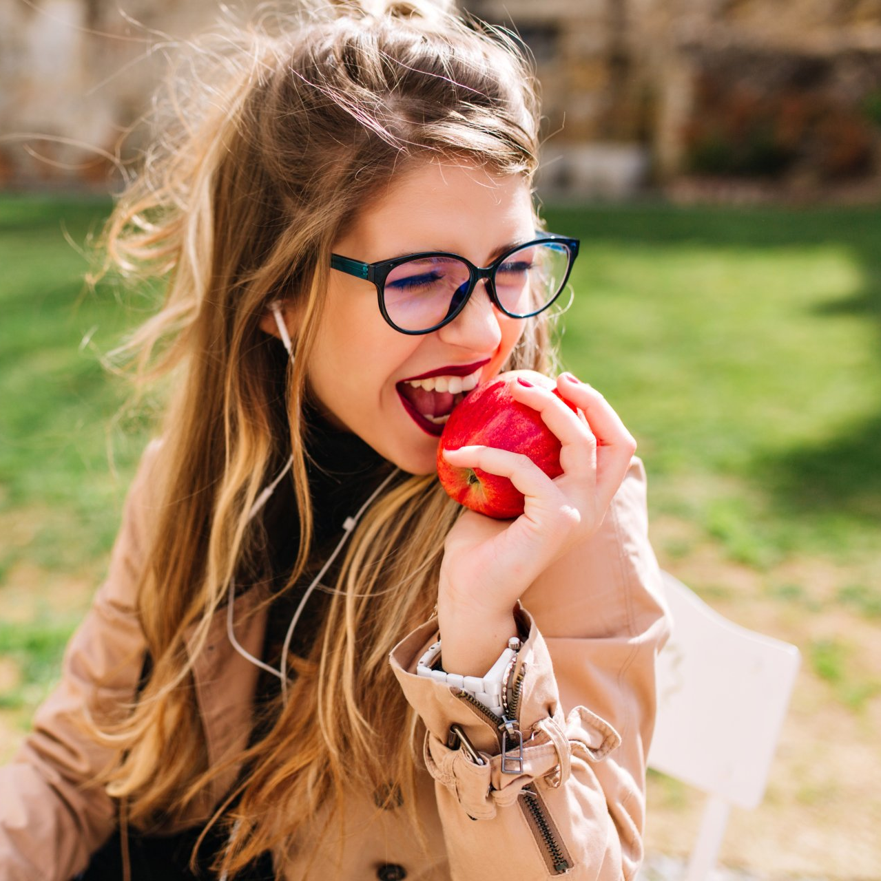 Young girl biting into an apple - Duxton Dental