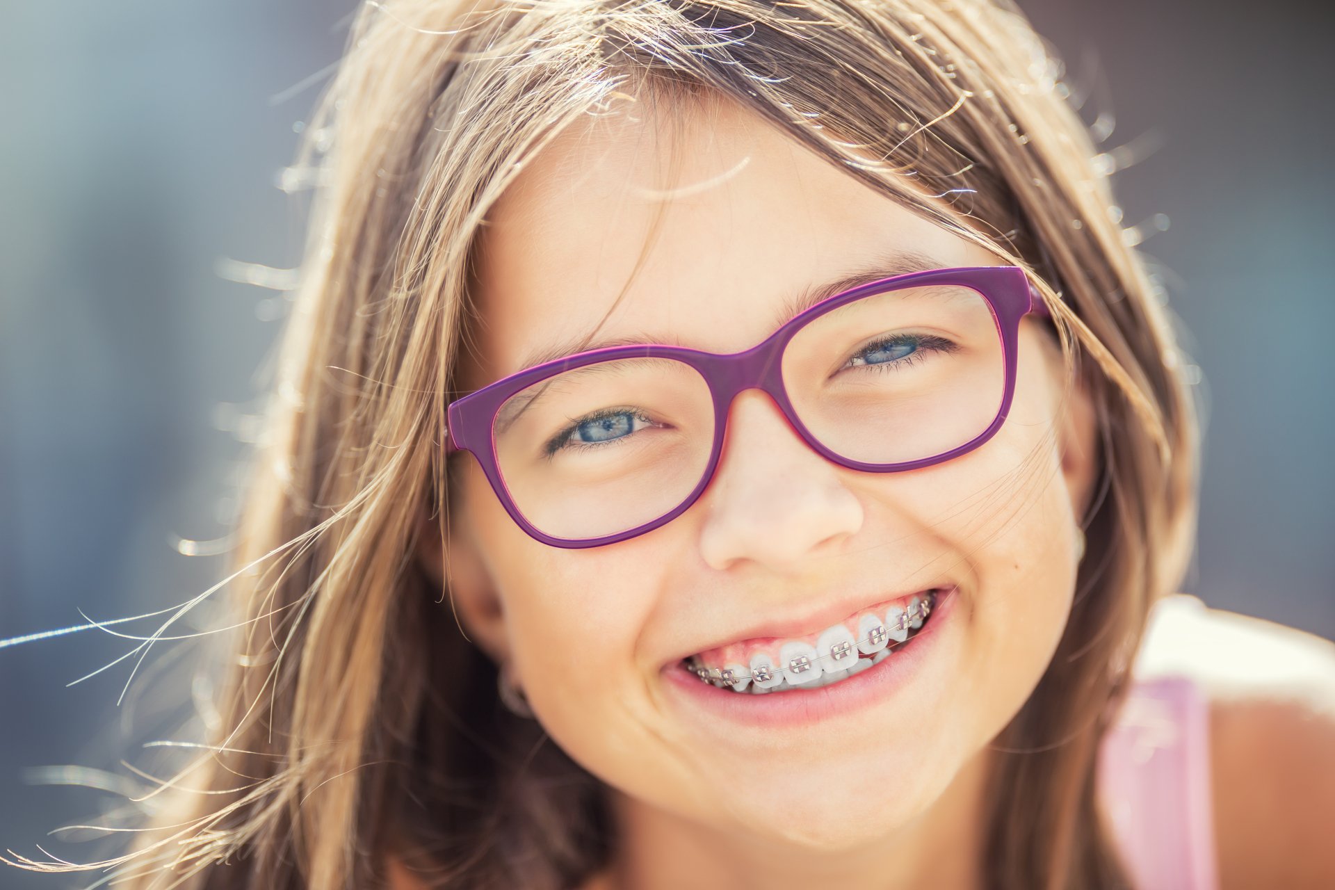 Girl checking her teeth after orthodontic treatment
