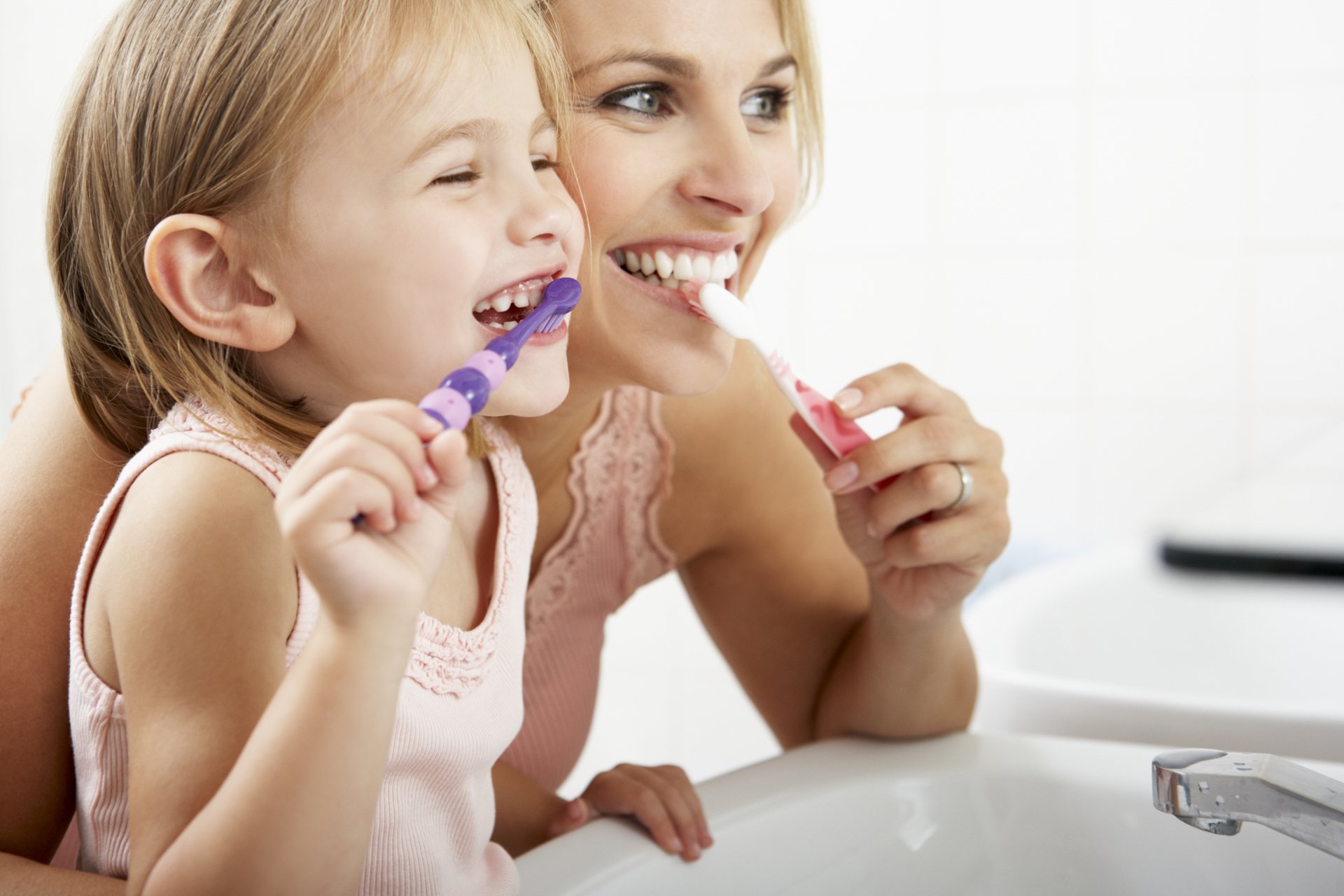 Mother and daughter brushing teeth - hygienist christchurch