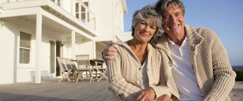 budget reblocking and underpinning elderly couple in front of a house with a deck