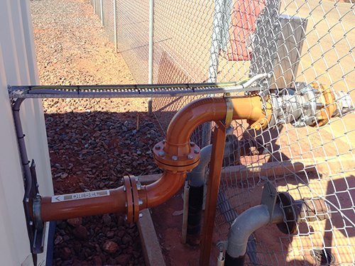 View of big orange color pipe coming out of the container