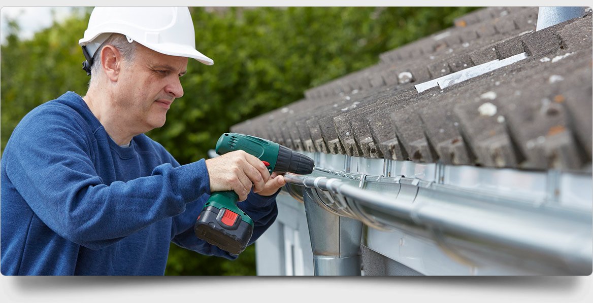 all oz roof plumbing screwing roof gutter into position