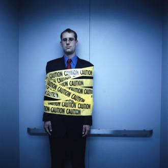 A professional with caution tape around him