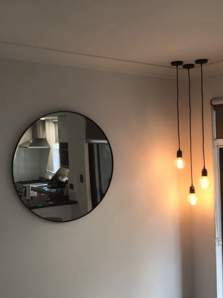 View of wall hang lights with round mirror