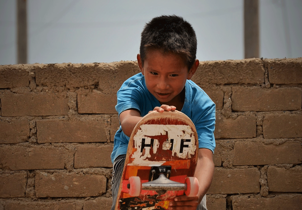 A local child enjoying Otra Cosa's skate ramp facility.