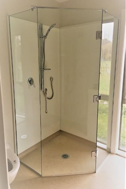 Image of solid wooden stairs with elegant glass balustrade