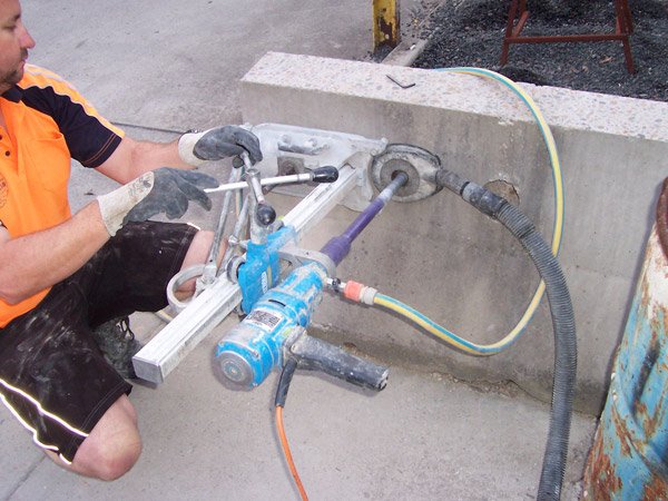 man drilling into concrete