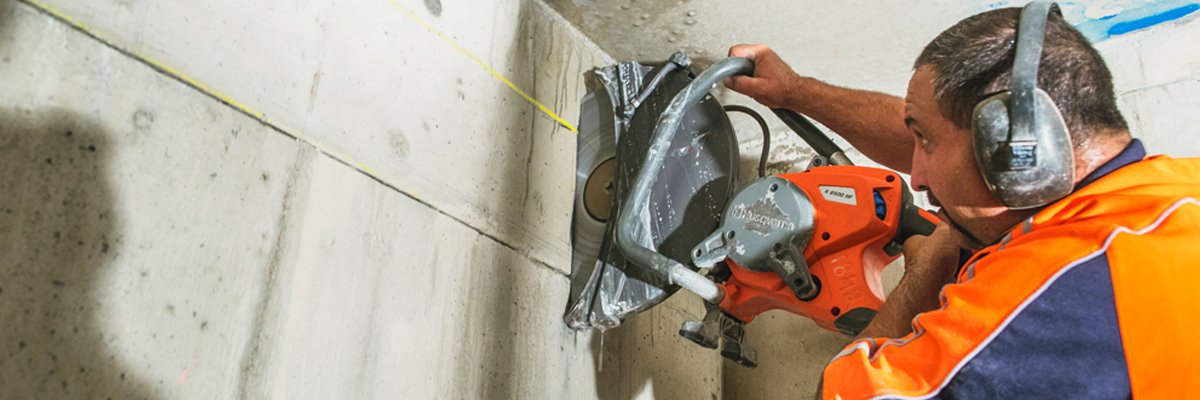 a 1 concrete services professional holding helmet